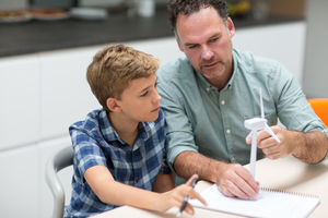 Father helping son with school project