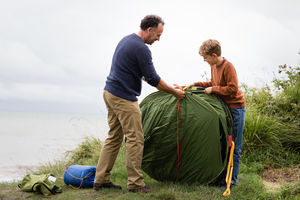 Father and Son putting up a tent together