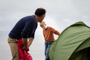 Father and Son putting up a tent together