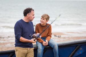 Father teaching Son how to fish