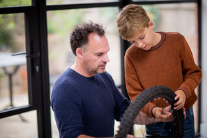 Father teaching Son how to care for his bicycle
