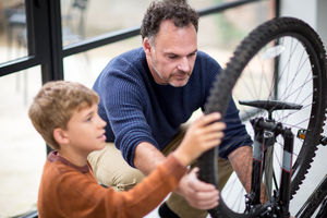 Father teaching Son how to care for his bicycle