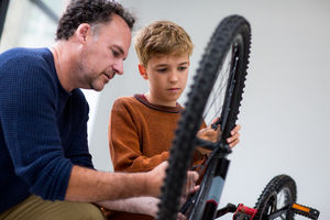 Boy fixing bike with his Dad