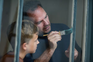 Father teaching Son how to decorate
