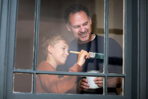 Son helping Father how to decorate
