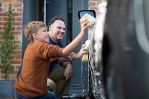 Son helping Father wash car