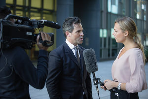 Businessman being interviewed on the street