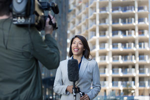 Female news presenter talking to camera