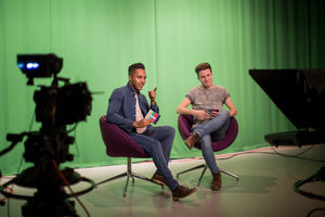 Presenters recording in a green screen studio