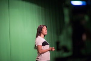 Presenter standing in a green screen studio