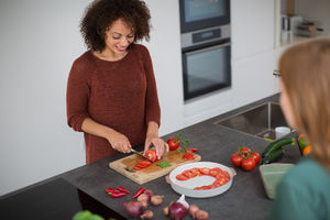African American female preparing meal for a friend