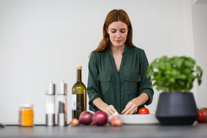 Adult female preparing meal with fresh ingredients