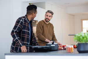 Adult male friends preparing a meal together