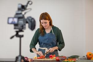 Adult female chef recording a video blog