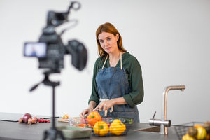 Adult female chef recording a video blog