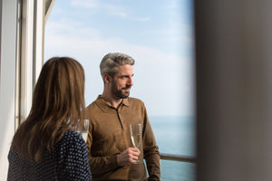 Couple enjoying view from balcony of sea