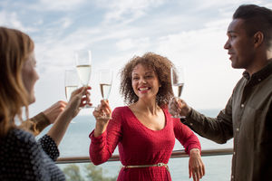 Friends enjoying view from balcony of sea