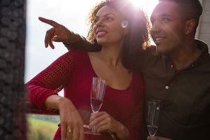 Couple enjoying view from balcony of sea