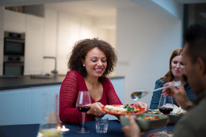 Adult male serving food to a friend