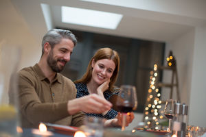 Couple looking at smartphone together at a meal