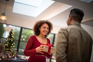 Woman being given Christmas gift