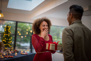 Woman being given Christmas gift