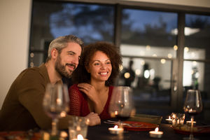 Multiracial couple having dinner with friends