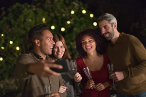 Friends celebrating outdoors taking a selfie