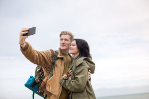 Young couple taking a selfie on a camping trip