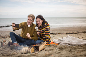 Young couple taking a selfie of their winter break