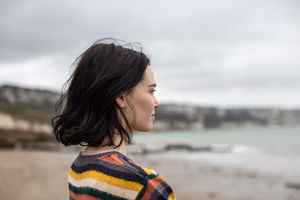 Young female looking at sea thoughtfully