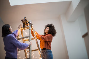 Friends decorating an alternative christmas tree