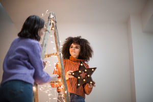 Friends decorating an alternative christmas tree