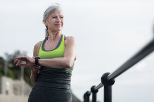 Senior woman warming up before a run