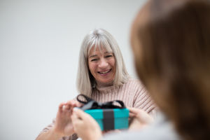Daughter giving Mother a gift