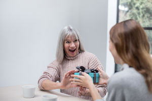 Daughter giving Mother a gift