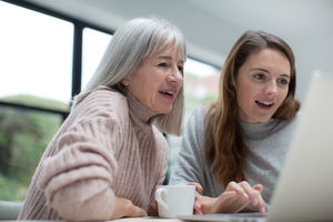 Mother and Daughter using a laptop together