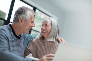 Happy senior couple using a laptop together