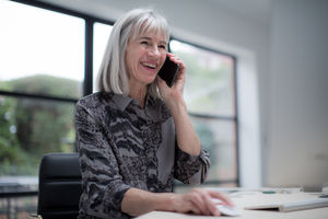Senior businesswoman multitasking technology