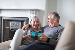 Senior couple with a gift