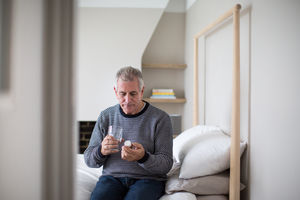 Senior man taking medicine