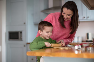 Mother and Son baking cookies in kitchen