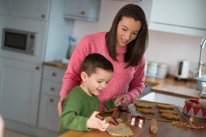 Mother and Son baking cookies in kitchen