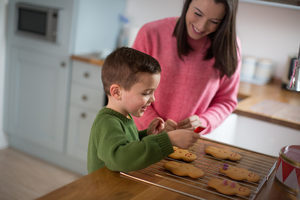 Mother and Son decorating gingerbread men