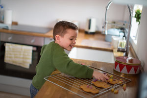 Boy decorating gingerbread men