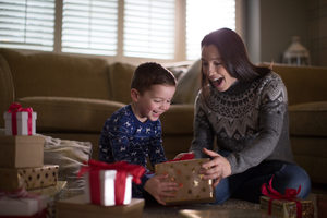 Mother and Son unwrapping Christmas gifts