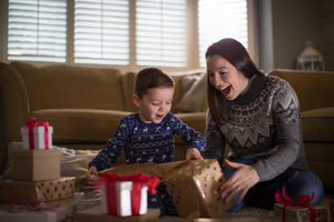 Mother and Son unwrapping Christmas gifts