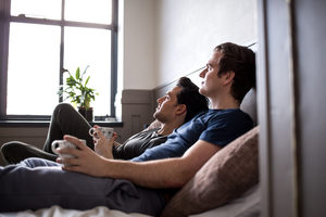 Young male couple relaxing with coffee