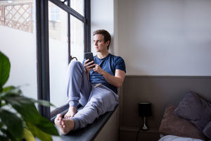 Young male with smartphone in the morning