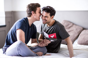 Young male couple with valentine card